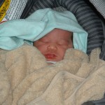 Newborn Eva in a carseat