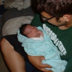 Chaz holding newborn Eva