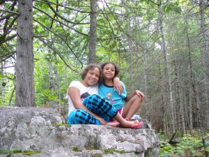 Lila and Eva posing on a boulder.