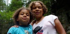 Lila and Eva posing on a rick in the river at Canyon Falls