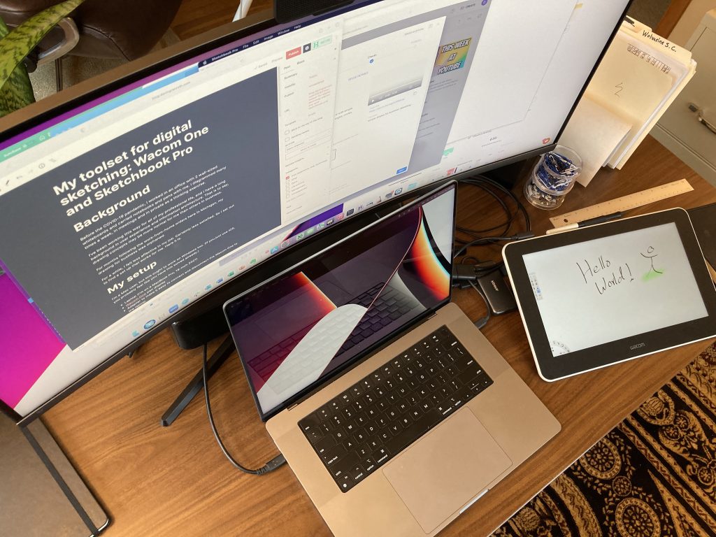 My desk set up with Mac laptop, external display, and Wacom One pen display.